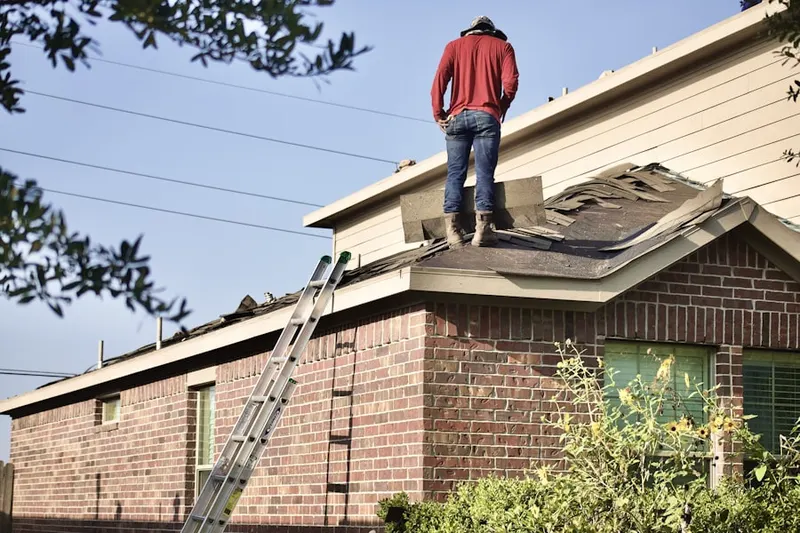 Professional roofer working on a residential roof in Kellam Place